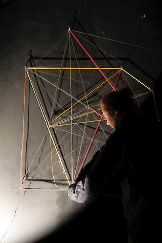 Eine scheinbar nutzlose Tätigkeit, wie das Spannen von Fäden, wird mit der Aktion Weile neu bespielt. Jede Bewegung und Berührung erzeugt durch die akustische Verstärkung eine klangliche Resonanz.